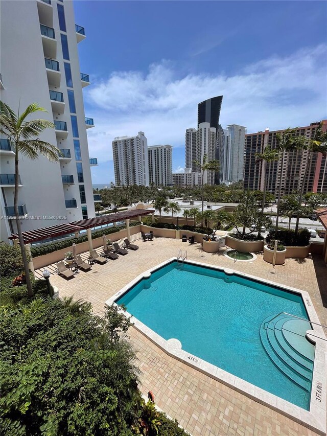 view of pool with a water view and a view of the beach