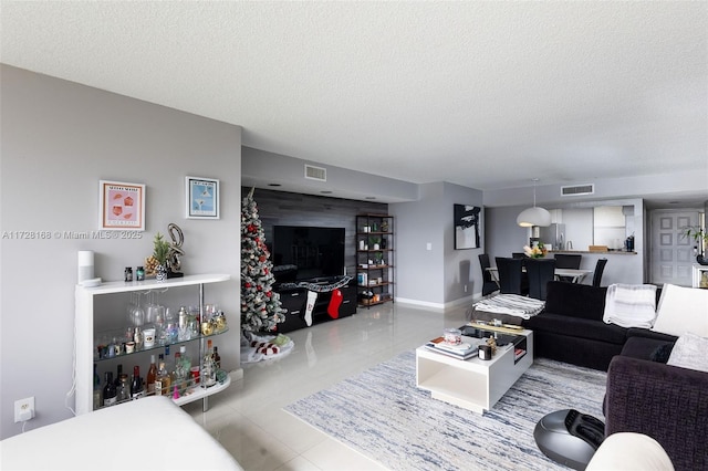 living room with light tile patterned floors and a textured ceiling