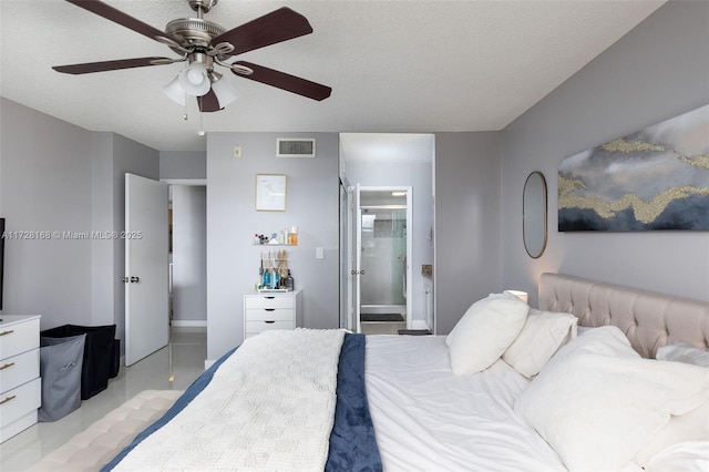 bedroom featuring a textured ceiling, ceiling fan, and connected bathroom