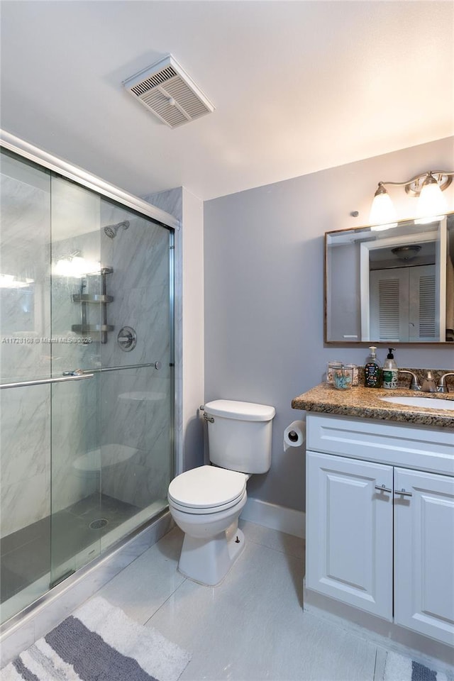 bathroom with toilet, vanity, an enclosed shower, and tile patterned floors