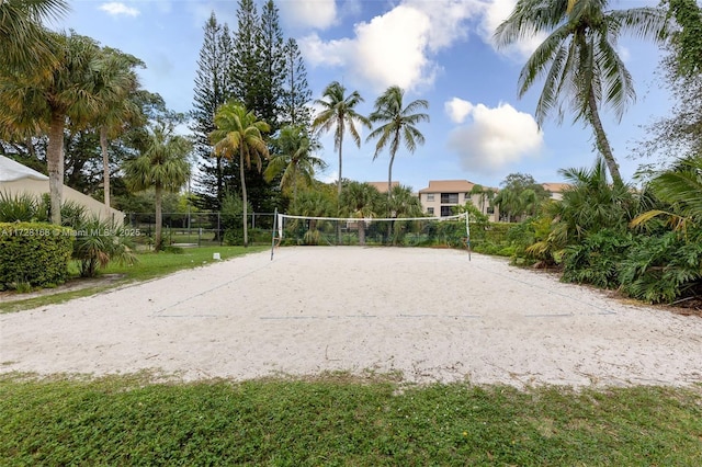 view of property's community featuring volleyball court and a lawn