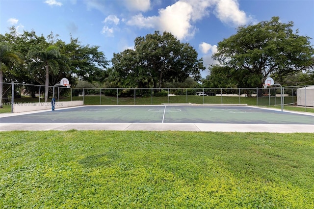 view of basketball court with a yard