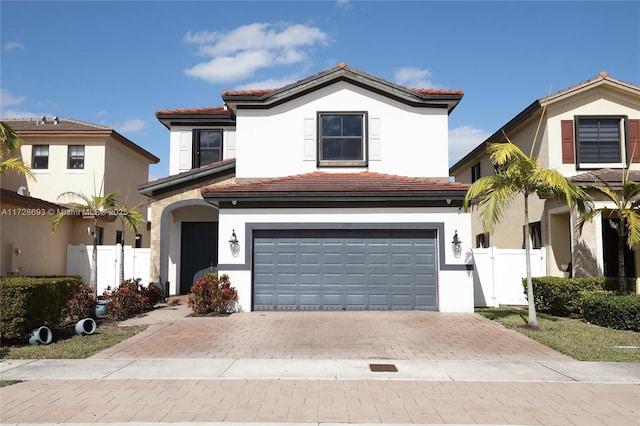 mediterranean / spanish home with a garage