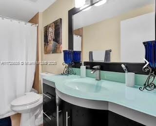 bathroom featuring toilet and vanity