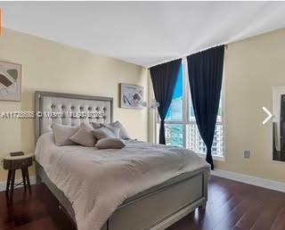 bedroom with dark wood-type flooring