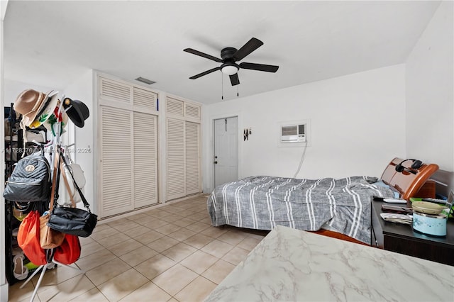 tiled bedroom featuring ceiling fan and a wall mounted air conditioner