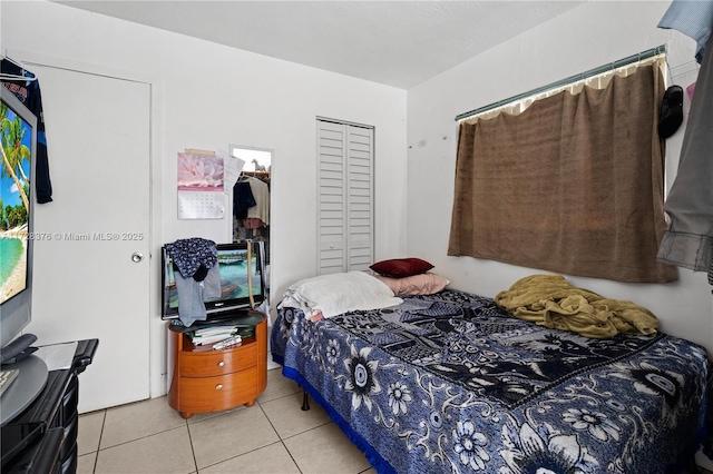 tiled bedroom featuring a closet