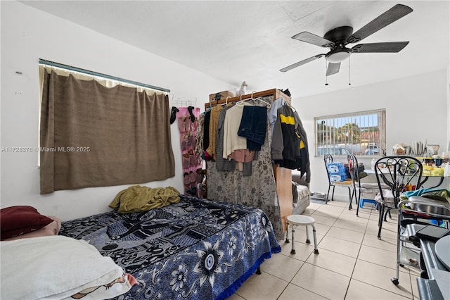 bedroom with ceiling fan and light tile patterned floors