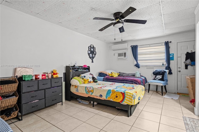 bedroom featuring ceiling fan, a wall mounted AC, and light tile patterned flooring