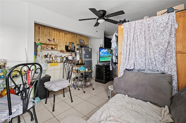 interior space with ceiling fan and stainless steel refrigerator