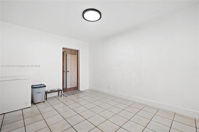 spare room with light tile patterned floors