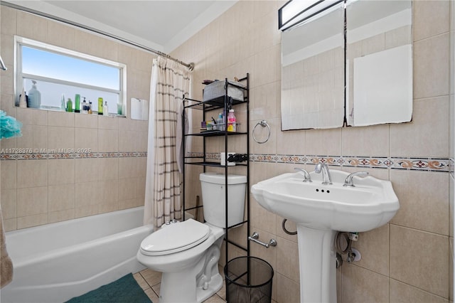 bathroom with tile walls, toilet, shower / tub combo, and tile patterned flooring