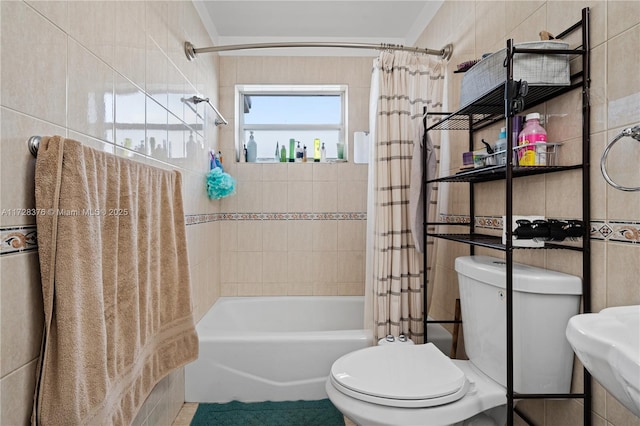 full bathroom with sink, tile walls, toilet, and shower / bath combo