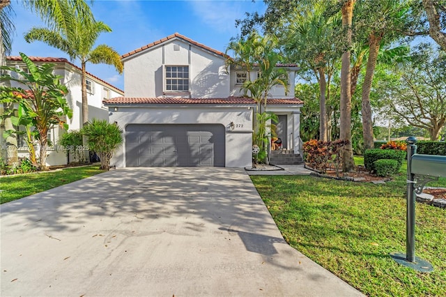 mediterranean / spanish-style house with a garage and a front lawn