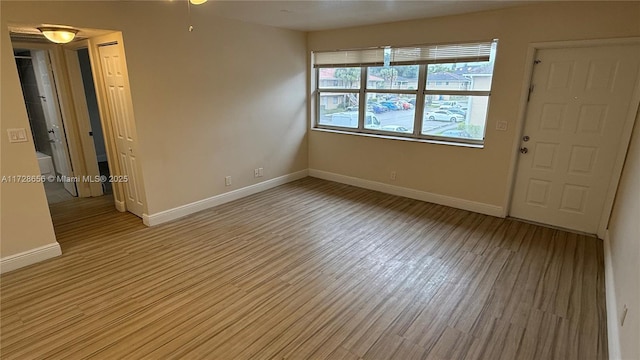 spare room with light hardwood / wood-style flooring