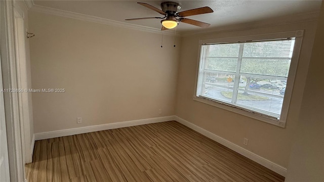 spare room featuring ceiling fan, light wood-type flooring, and crown molding