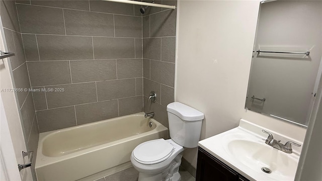 full bathroom featuring toilet, vanity, tiled shower / bath, and tile patterned flooring