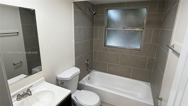 full bathroom with toilet, vanity, and tiled shower / bath