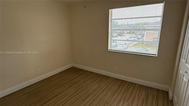 empty room with wood-type flooring