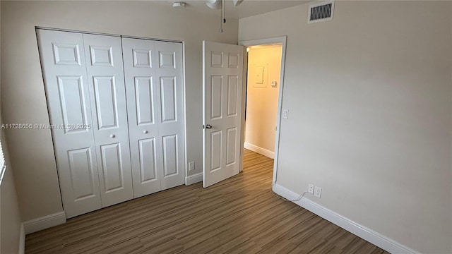 unfurnished bedroom featuring hardwood / wood-style flooring and a closet