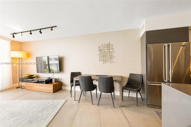 living room with rail lighting and light tile patterned flooring