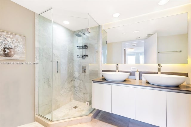 bathroom with walk in shower and vanity