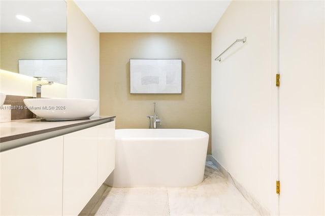 bathroom featuring vanity and a tub