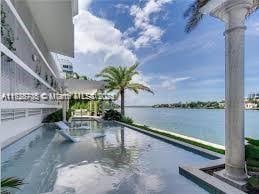 view of swimming pool with a water view