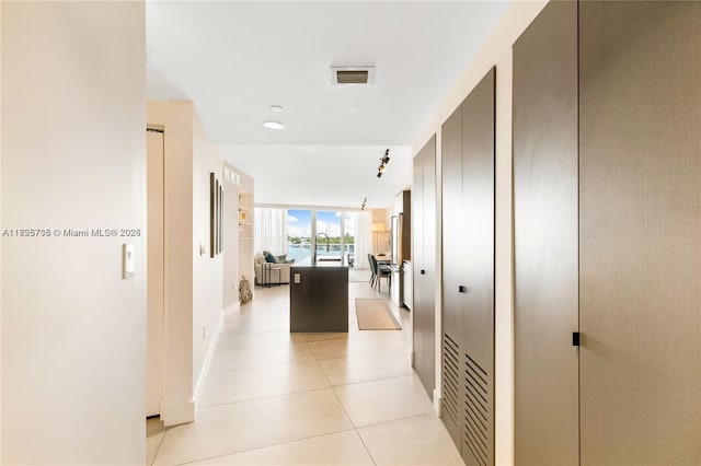 corridor featuring light tile patterned flooring