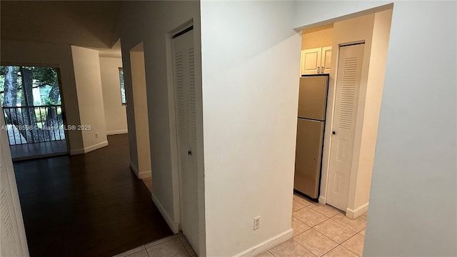 hall featuring light tile patterned floors