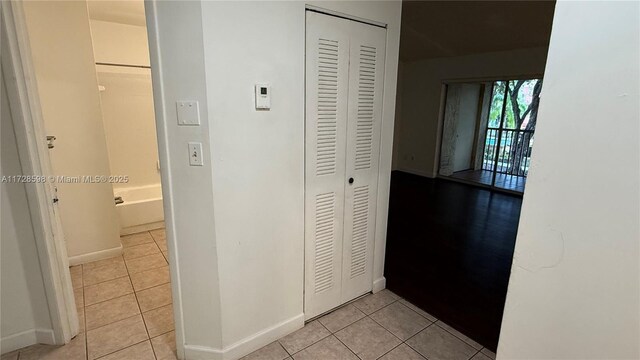 hall featuring light tile patterned floors