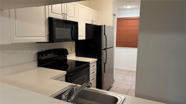 kitchen featuring black appliances, white cabinets, sink, and light tile patterned flooring