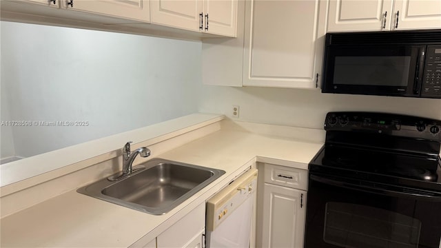 kitchen with black appliances, white cabinets, and sink