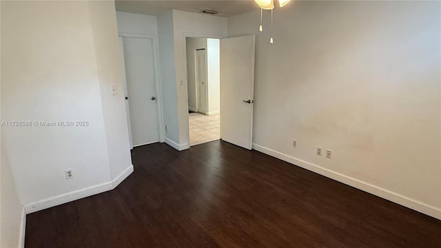 spare room with dark hardwood / wood-style floors