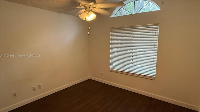 spare room featuring ceiling fan, dark hardwood / wood-style flooring, and a textured ceiling