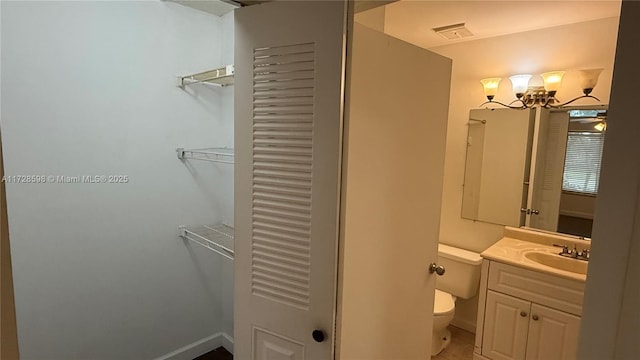 bathroom featuring toilet, vanity, and tile patterned flooring