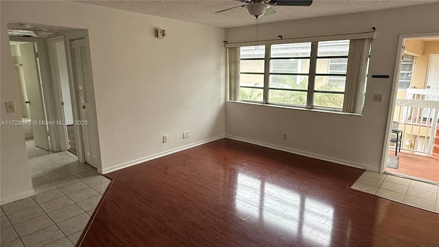 spare room with ceiling fan, tile patterned floors, and a textured ceiling