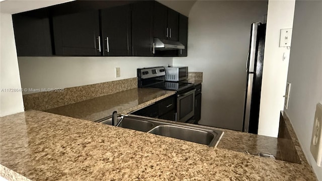 kitchen with appliances with stainless steel finishes, light stone counters, and sink