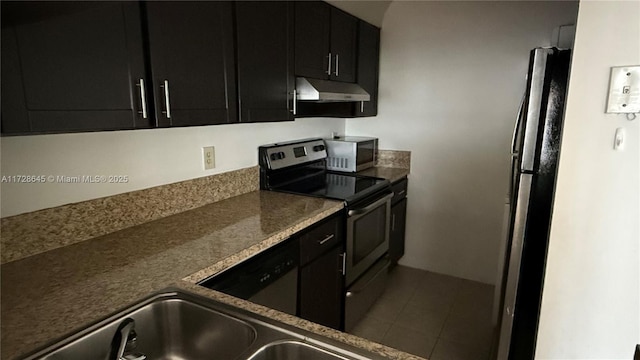 kitchen featuring appliances with stainless steel finishes and dark tile patterned floors