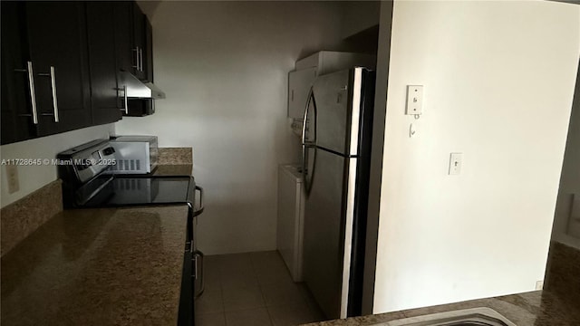 kitchen featuring stainless steel fridge and black electric range