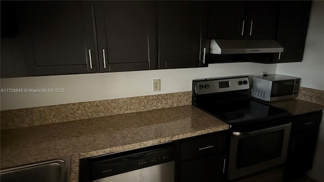 kitchen featuring appliances with stainless steel finishes, wall chimney exhaust hood, and sink