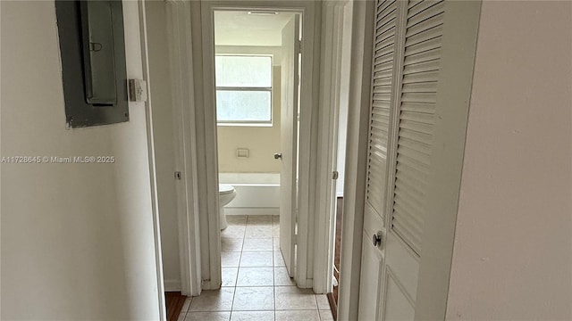 hallway featuring light tile patterned floors and electric panel