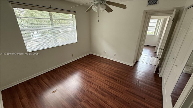 empty room featuring ceiling fan and dark hardwood / wood-style floors