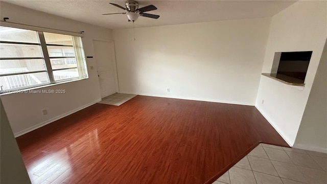 spare room featuring ceiling fan and light tile patterned floors