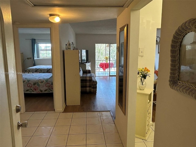 hall featuring light tile patterned flooring