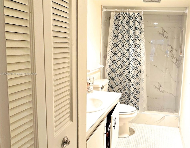 bathroom with toilet, vanity, a shower with curtain, and tile patterned floors