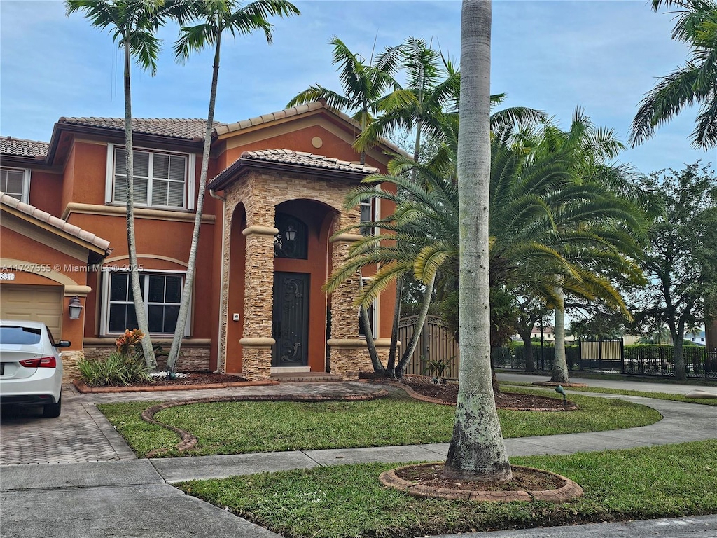 mediterranean / spanish home featuring a front yard