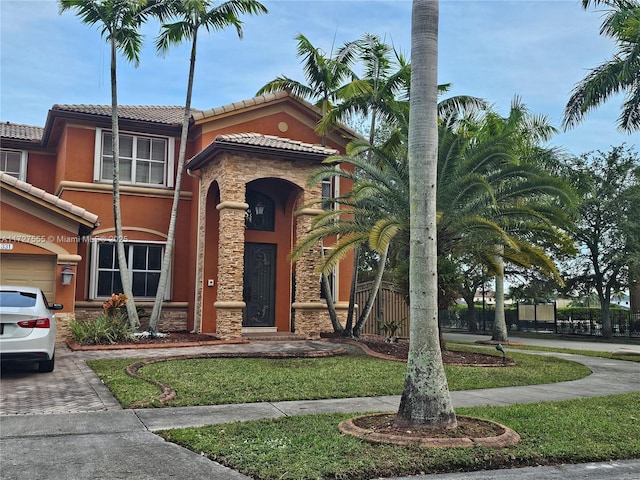 mediterranean / spanish home featuring a front yard