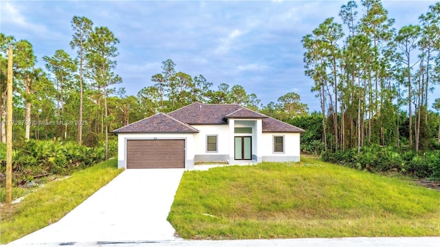 mediterranean / spanish-style home with a front yard and a garage