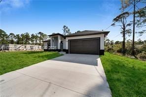 view of front of home featuring a front yard and a garage